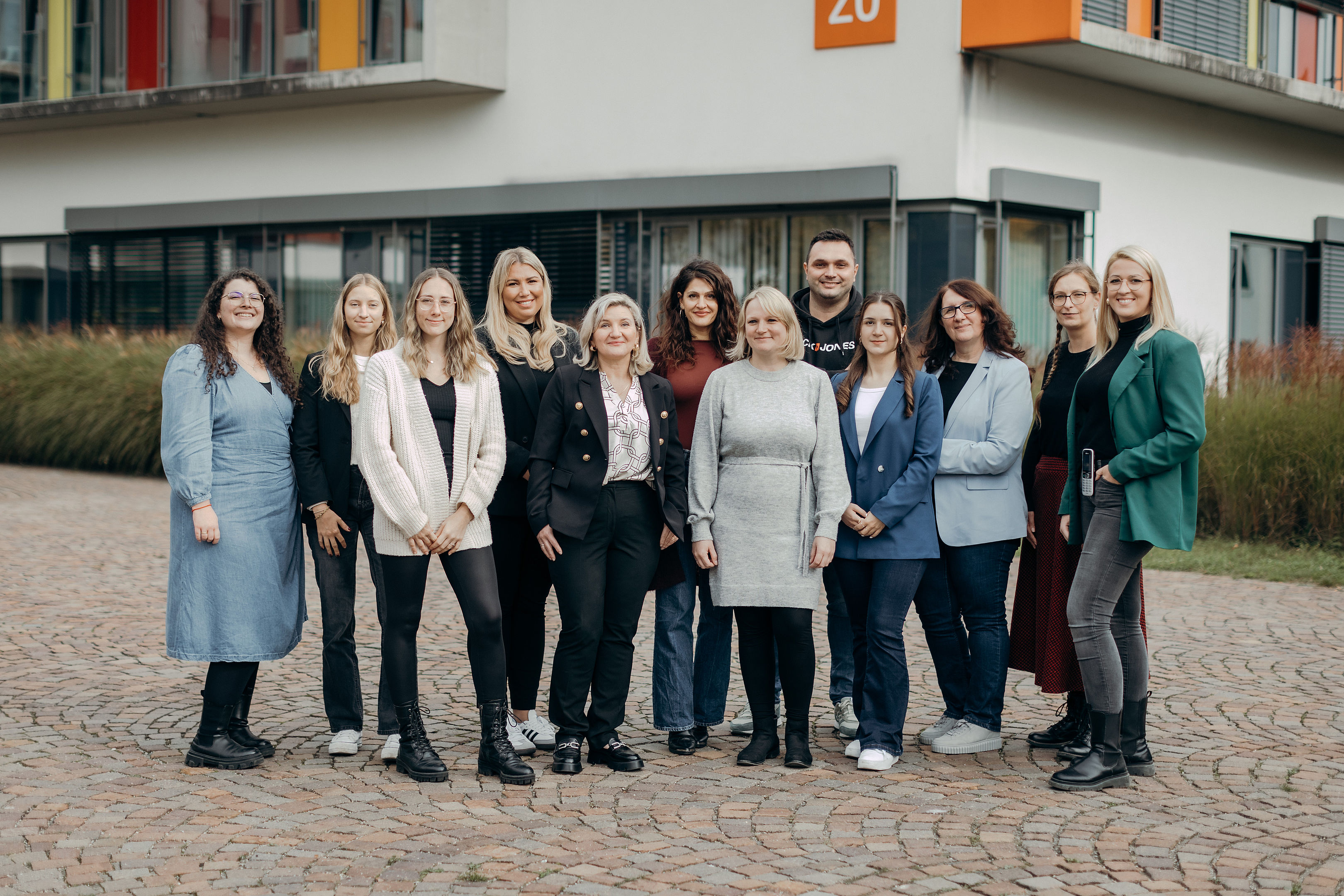 Gruppenfoto des IFAP-Teams des Universitätsklinikums Augsburg vor einem modernen Gebäude.